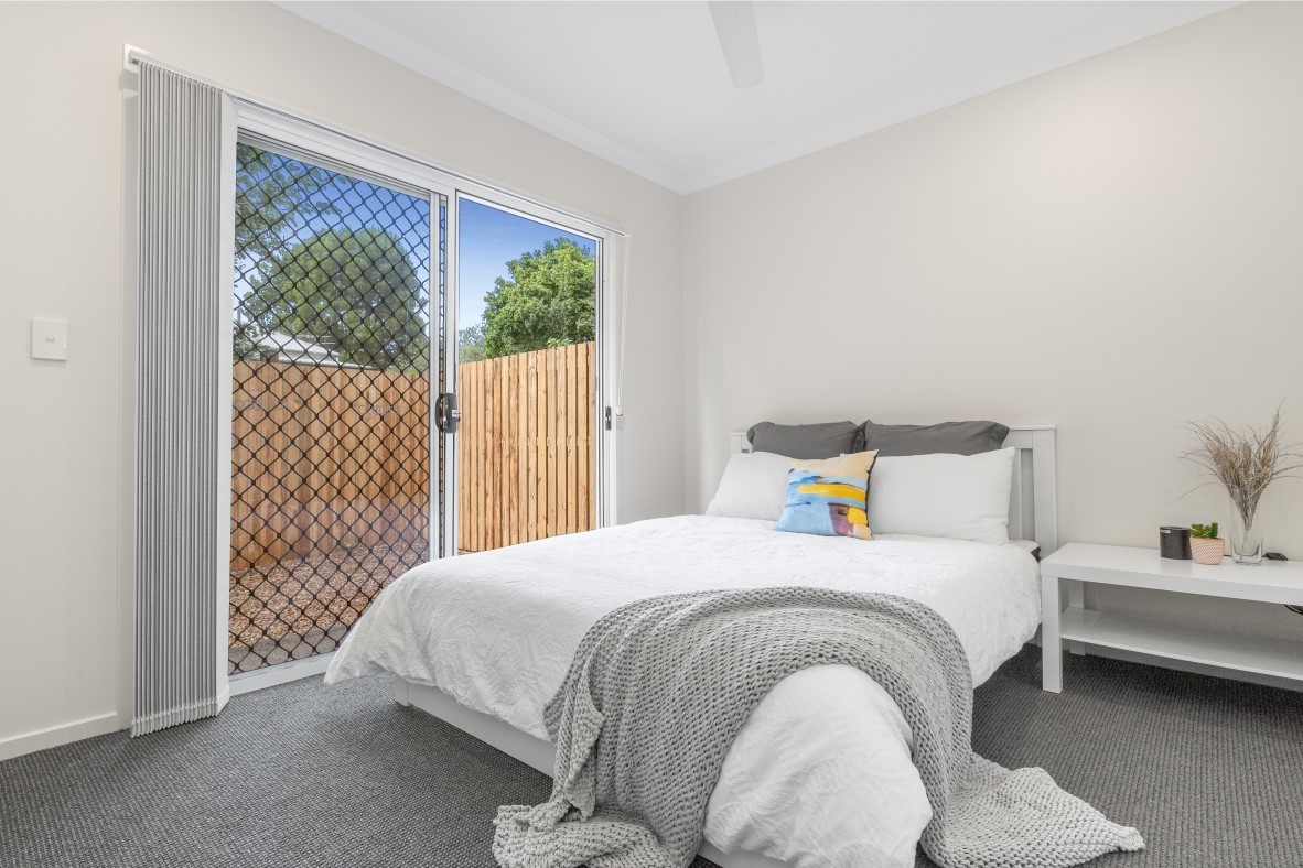 Bright private bedroom with garden views.
